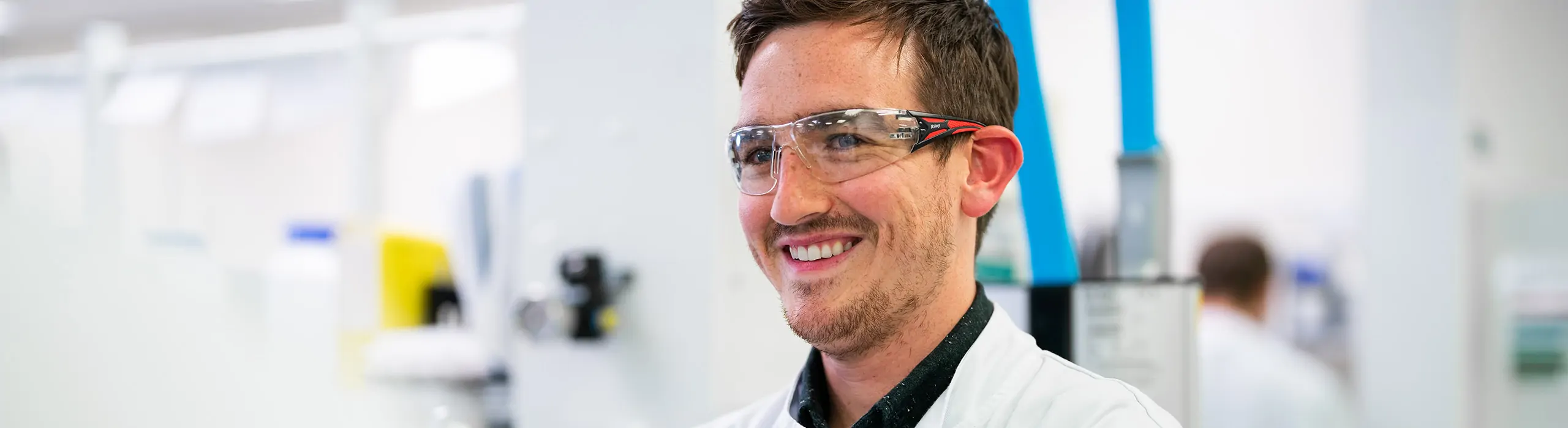 male technician smiling in lab