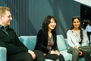 three employees in a meeting space