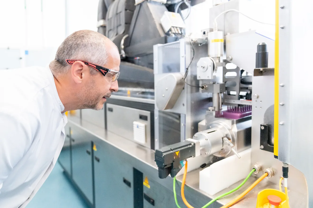 Researcher inspecting production of a small batch of bespoke polymer enteric capsules at Lonza Innovaform lab Colmar France